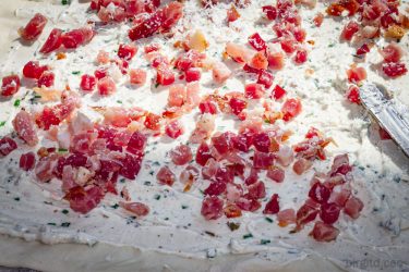 Schinkenwürfel auf der Frischkäse-Kräutercreme verteilt